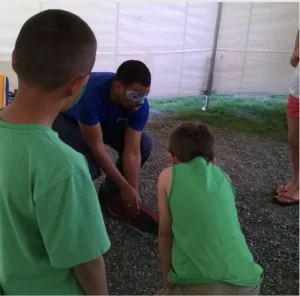 Junior natural resources major William C. Moore III teaches kids about wildlife during his internship with the Kenai National Wildlife Refuge.